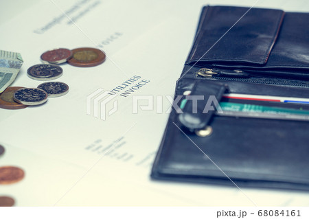 Man signs a utilities invoice with a ballpoint pen 68084161