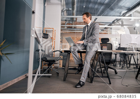 Stylish businessman using modern laptop at work Stylish businessman using modern laptop at work 68084835