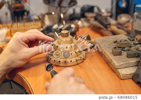 Young Caucasian craftsman working at the workbench 68086015