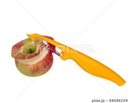 Yellow peeler, used to peel an apple on white background. Knife, peeler for vegetables and fruits Yellow peeler, used to peel an apple on white background. Knife, peeler for vegetables and fruits 68086209