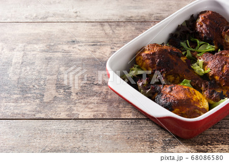 Roasted tandoori chicken with basmati rice on wooden table	 68086580