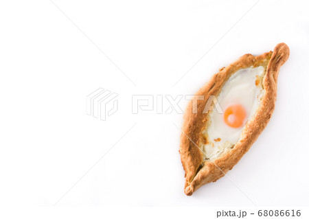 Traditional Adjarian Georgian khachapuri with cheese and egg isolated on white background. Top view Traditional Adjarian Georgian khachapuri with cheese and egg isolated on white background. Top view 68086616