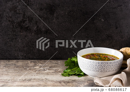 Indian lentil soup dal (dhal) in a bowl on wooden table Indian lentil soup dal (dhal) in a bowl on wooden table 68086617