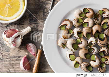 Escargots de Bourgogne on wooden table. Top view	 68086647