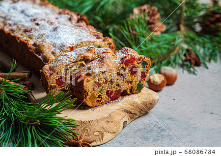 Traditional Christmas fruit cake on a wooden board Traditional Christmas fruit cake on a wooden board 68086784