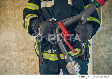 Portrait of man hands with water hose 68086797
