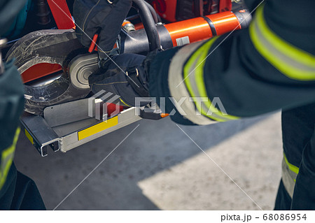 Firefighter is installing equipment on the fire truck 68086954