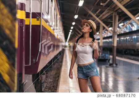 Young Hispanic woman about to board train 68087170