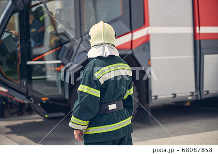 Back view of man at the fire station in outdoors Back view of man at the fire station in outdoors 68087858