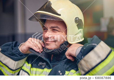 Portrait of fireman in protective uniform and helmet 68087886