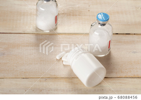 Various pill bottles and different pills on wooden table Various pill bottles and different pills on wooden table 68088456