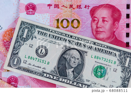 One dollar and One hundred Chinese renminbi RMB bills. CNY background. Closeup of Benjamin Franklin and Mao Zedong . US dollars background. American currency. Chinese currency. China 68088511