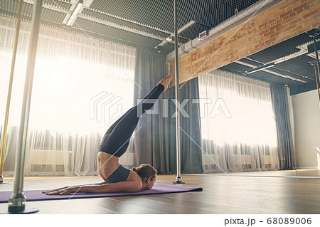 Sporty young woman practicing yoga in studio 68089006