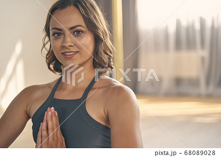 Cheerful young woman practicing yoga in studio 68089028
