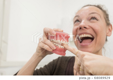 Funny woman playing with jaws in dentist clinic 68089929