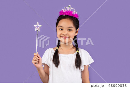 Japanese Girl Wearing Crown Holding Magic Stick Over Purple Background 68090038