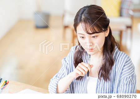 リビングでリモートワーク中の若い女性。 リビングでリモートワーク中の若い女性。 68090270