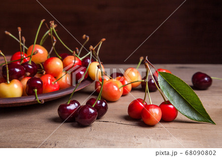 Clay plate with yellow and red sweet cherry on Clay plate with yellow and red sweet cherry on 68090802