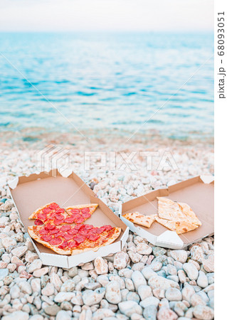 Fresh pizza on the beach background of the sea Fresh pizza on the beach background of the sea 68093051