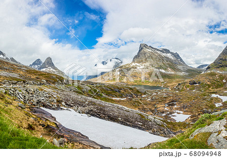 Snowy mountains peaks around Alnesvatnet lake 68094948
