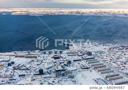Aerial view to the fjord and snow streets of 68094987