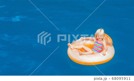 Child swimming with fun on inflatable floating 68095911