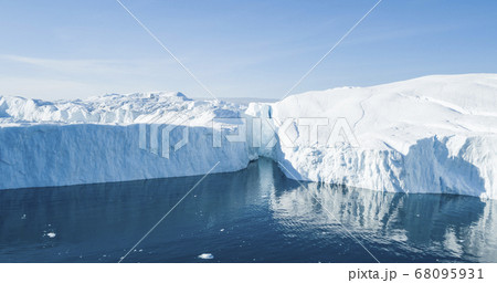 Global Warming and Climate Change - Icebergs from melting glacier on Greenland Global Warming and Climate Change - Icebergs from melting glacier on Greenland 68095931