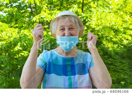 Happy positive smiling senior woman takes off 68096166