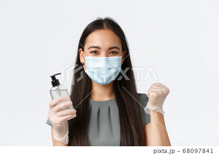 Small business owners, covid-19, preventing virus measures concept. Confident asian woman getting back to work after quarantine, wear medical mask and gloves, using hand sanitizer Small business owners, covid-19, preventing virus measures concept. Confident asian woman getting back to work after quarantine, wear medical mask and gloves, using hand sanitizer 68097841