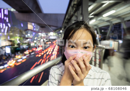 Sick asian people wearing protective mask,child girl has cough,choking on air pollution,problems of toxic dust,smog,fine dust,air pollution or PM2.5,outdoor in city,danger to the respiratory system Sick asian people wearing protective mask,child girl has cough,choking on air pollution,problems of toxic dust,smog,fine dust,air pollution or PM2.5,outdoor in city,danger to the respiratory system 68108046