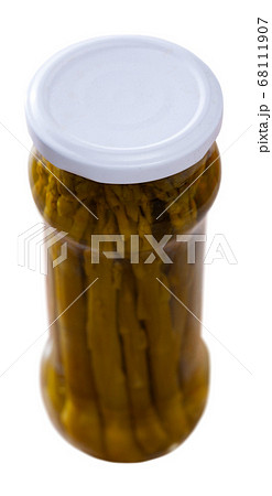 Closed glass jar with pickled green asparagus 68111907