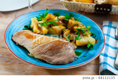 Roasted pork chop with grilled potatoes garnish Roasted pork chop with grilled potatoes garnish 68112135