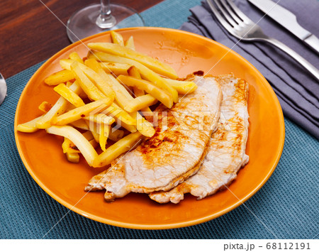 Homemade baked pork chops with French fries Homemade baked pork chops with French fries 68112191