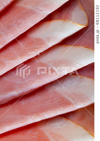 Sliced appetizing ham closeup wooden board 68112192
