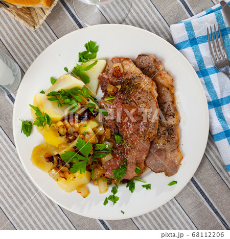 Appetizing fried pork with potatoes and herbs 68112206