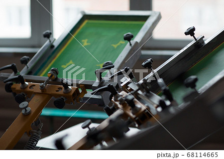 Silk screen printing. Serigraphy. Color paints and fabric. Carousel machine. Silk screen printing. Serigraphy. Color paints and fabric. Carousel machine. 68114665