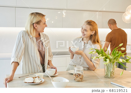 Modern Family in Kitchen Interior 68119521