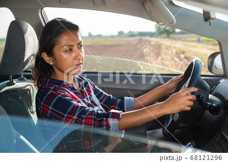 Portrait of latino woman driver in car 68121296