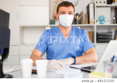 General practitioner listening to patient in office General practitioner listening to patient in office 68121339