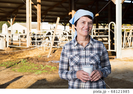 Active woman is holding glass of milk 68121985