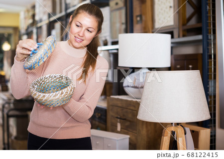 Woman buying wicker basket Woman buying wicker basket 68122415