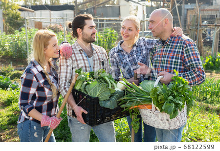 Couples holding harvest of vegetables Couples holding harvest of vegetables 68122599