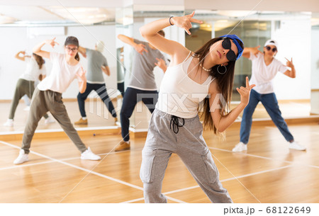 Teenagers boy and girls performing hip hop at group class Teenagers boy and girls performing hip hop at group class 68122649