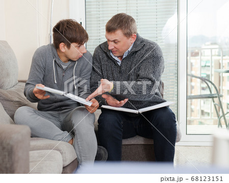 Father and son teenager can not solve school assignments 68123151