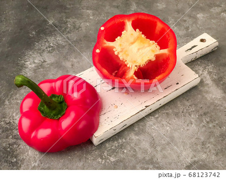 halved red bell pepper on a cutting board 68123742