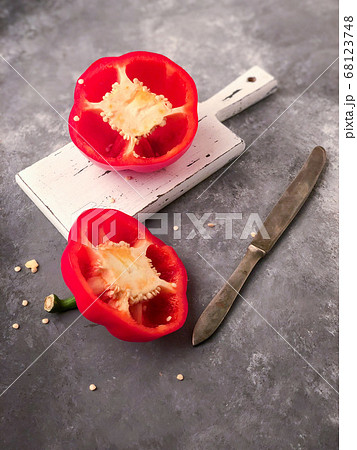 halved red bell pepper on a cutting board 68123748