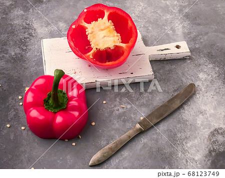 halved red bell pepper on a cutting board 68123749