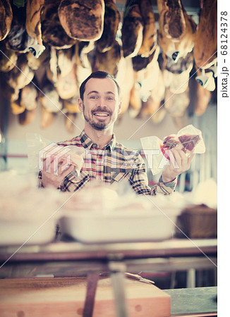 Seller offering sorts of meat Seller offering sorts of meat 68124378