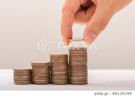 Hand putting coins on stack on table,Saving money 68126299
