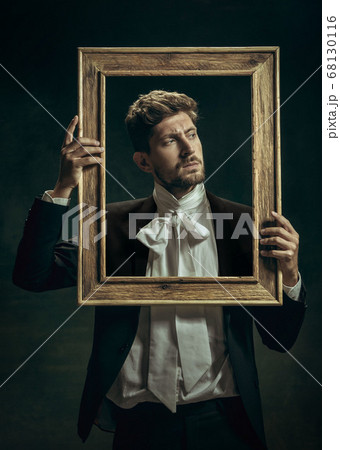 Young man as Dorian Gray on dark background. Retro style, comparison of eras concept. 68130116